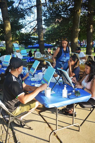 Under the direction of artist Xenia Rose Schafer, participants create their own works of art.  Schafer was sharing her skills during a Sept. 25 outdoor gathering at Friendship Park to celebrate Hispanic Heritage Month.