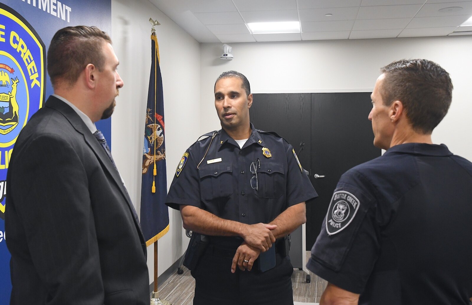 Battle Creek Police Chief Shannon Bagley, center, talks with Lt. Ryan Strunk, left, and Deputy Chief Doug Bagwell.