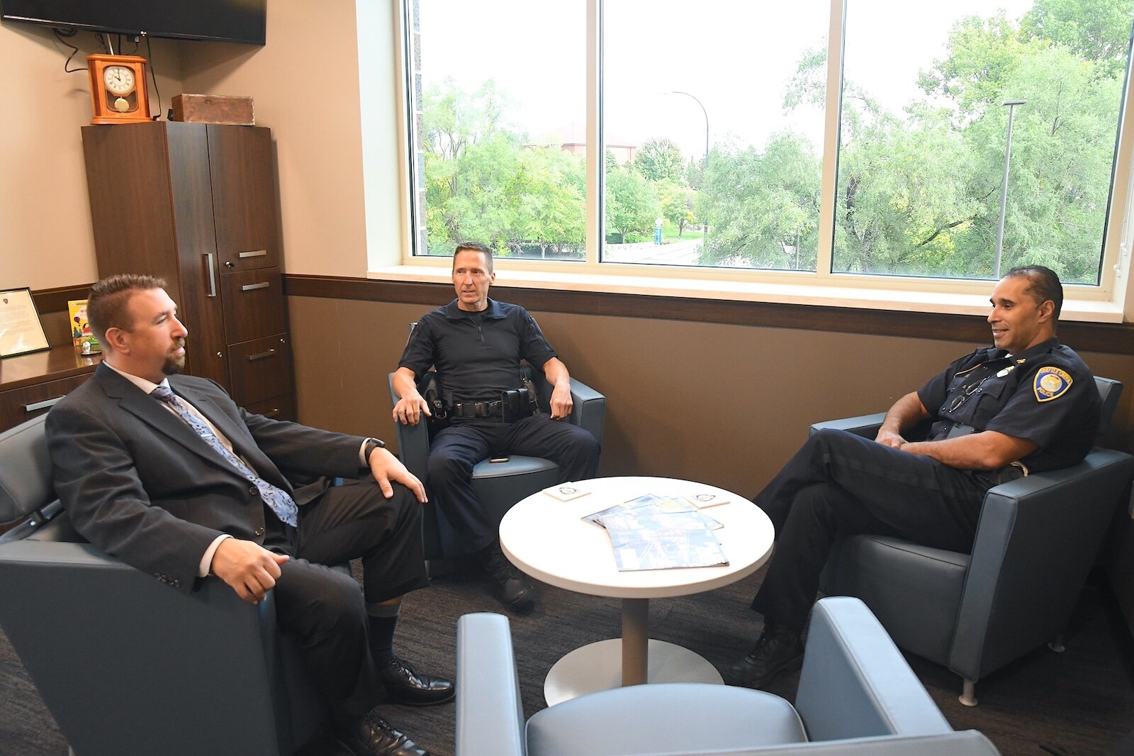 Battle Creek Police officers converse, from left, Lt. Ryan Strunk, Deputy Chief Doug Bagwell, and Police Chief Shannon Bagley.