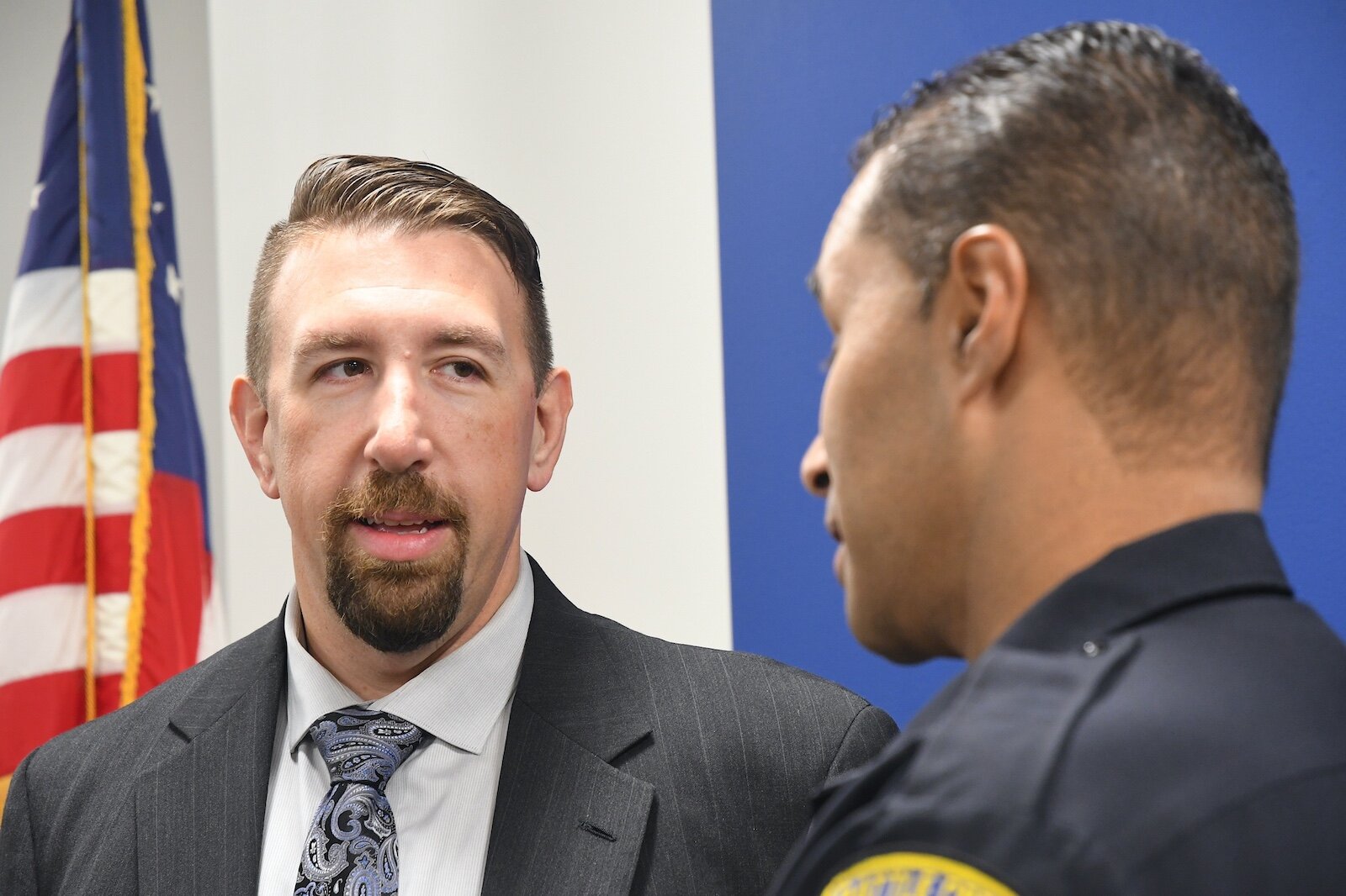 Battle Creek Police Lt. Ryan Strunk, left, listens to a fellow officer.