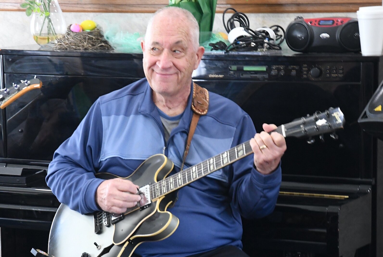 Don Bradford performs on the electric guitar for residents of Park Place Assisted Living in Kalamazoo.