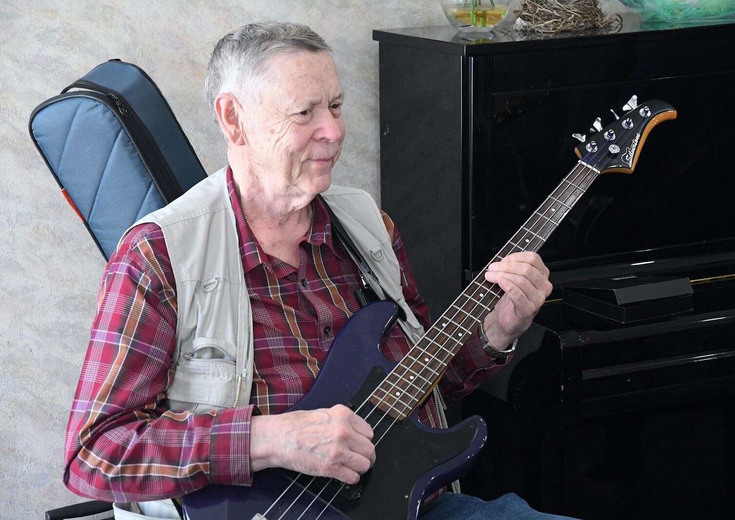 Rendal Wall performs on the electric bass for residents of Park Place Assisted Living in Kalamazoo.
