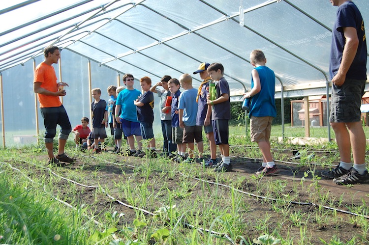 Branden Piekarski, Farm Project Manager, in the hoop house.