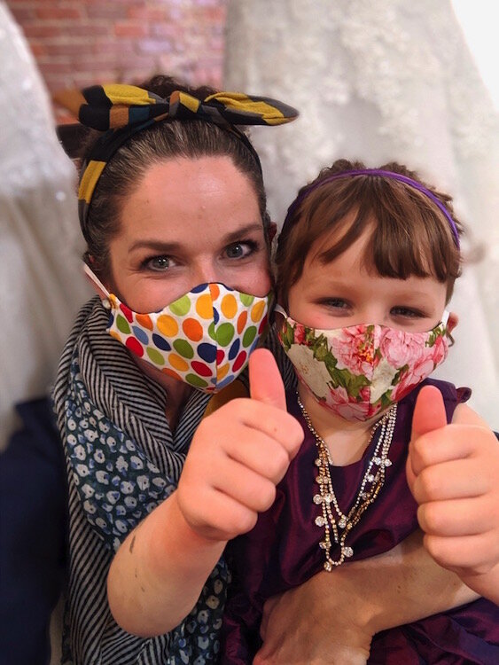 Shop owner Adrienne Wissner and her daughter Piper are shown with their homemade masks. The staff at Memories Bridal & Evening Wear is wearing masks made by Wissner using fabric from dress garment bags.