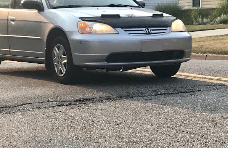 A car travels over a speed hump on Kalamazoo's West Side, similar to what is being proposed as a solution to speeding in other neighborhoods.