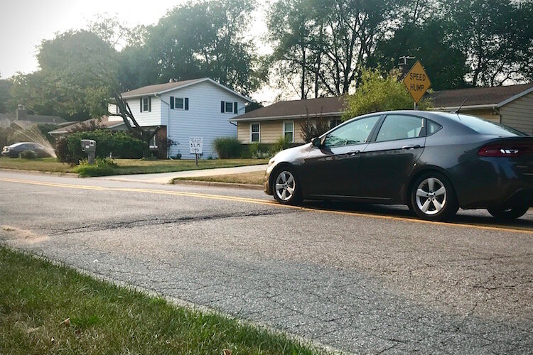 A car travels over a speed hump on Kalamazoo's West Side, similar to what is being proposed as a solution to speeding in other neighborhoods.