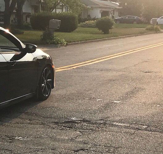 A car travels over a speed hump on Kalamazoo's West Side, similar to what is being proposed as a solution to speeding in other neighborhoods. 