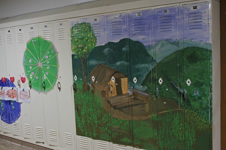  A row of lockers at Catching the Dream Learning Center is decorated with a rural Burma scene and pretty umbrellas.