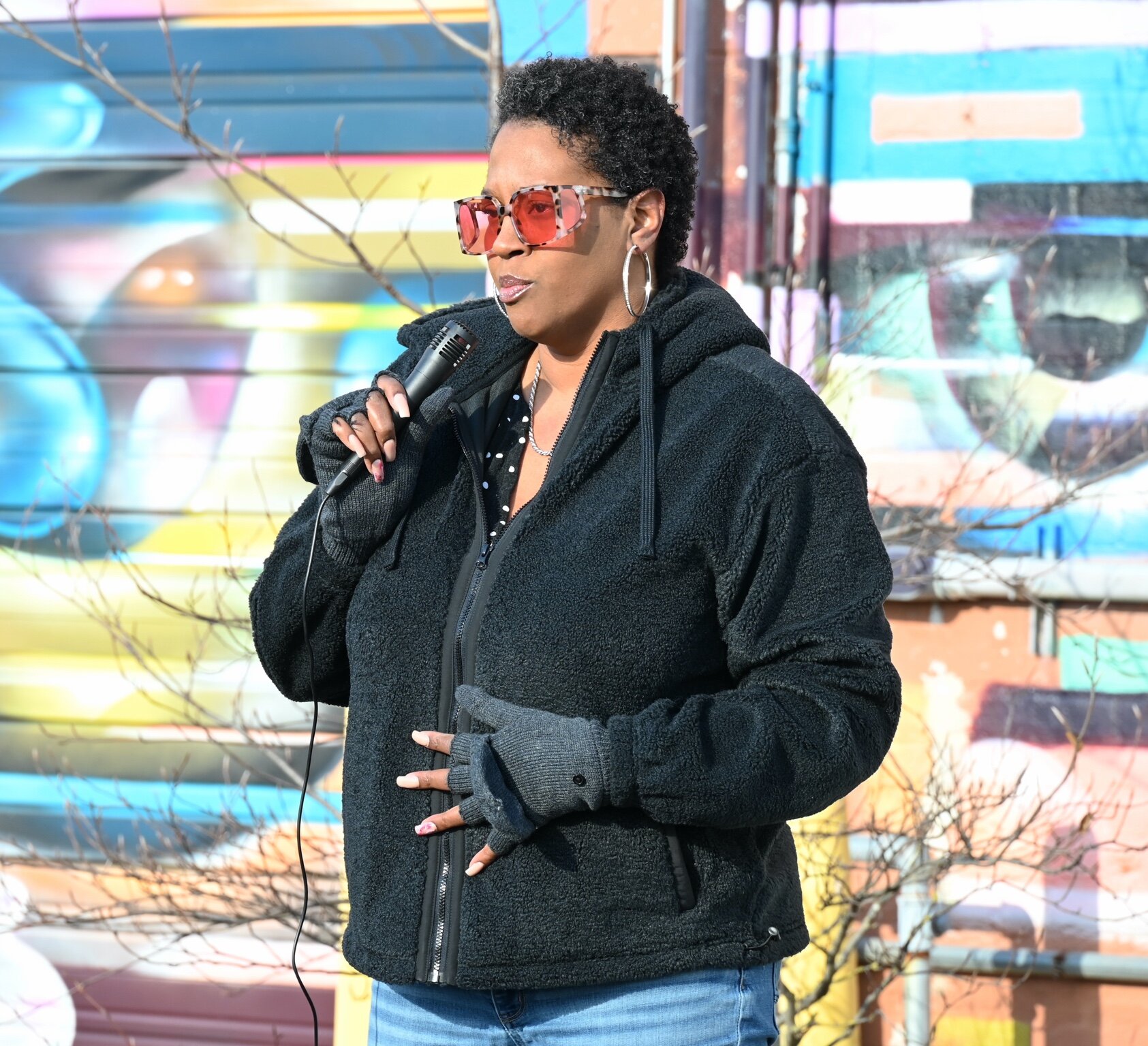 Boonikka Herring, Racial Healing Coordinator at Battle Creek Coalition for Truth, Racial Healing, and Transformation, speaks during Sunday afternoon’s vigil behind Cafe Rica.