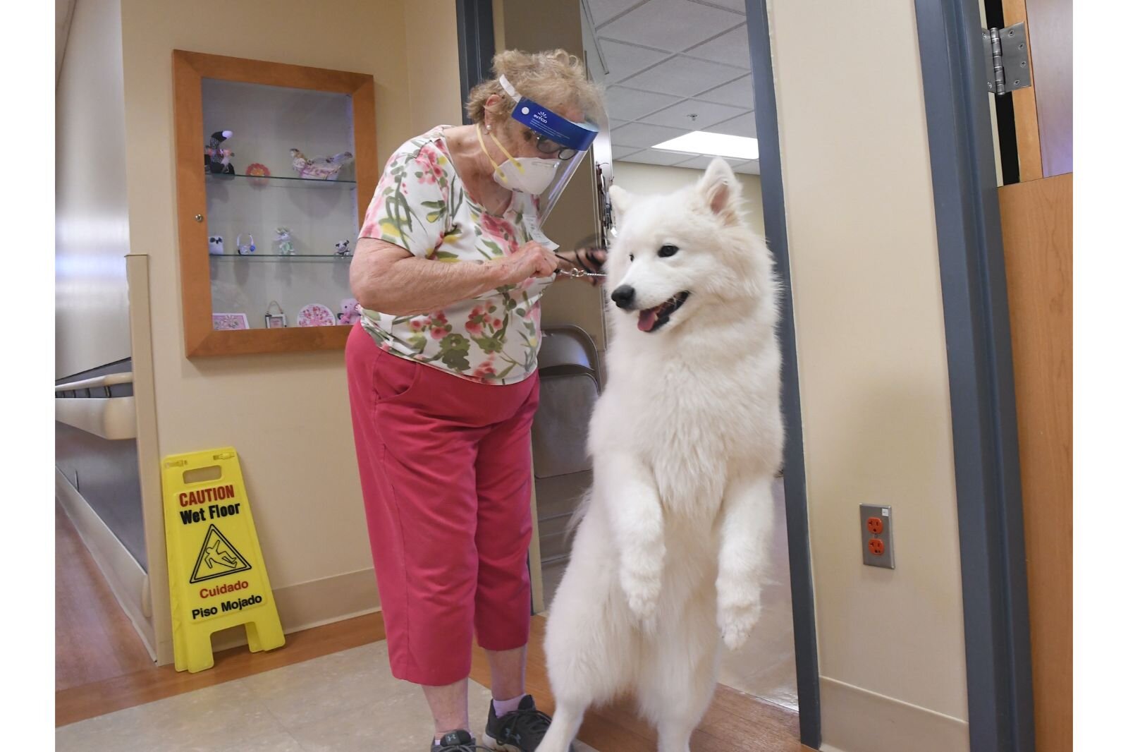 Carol Miller and Patty, her one-year old therapy dog, leave a patient’s room at the Calhoun County Medical Care Facility.