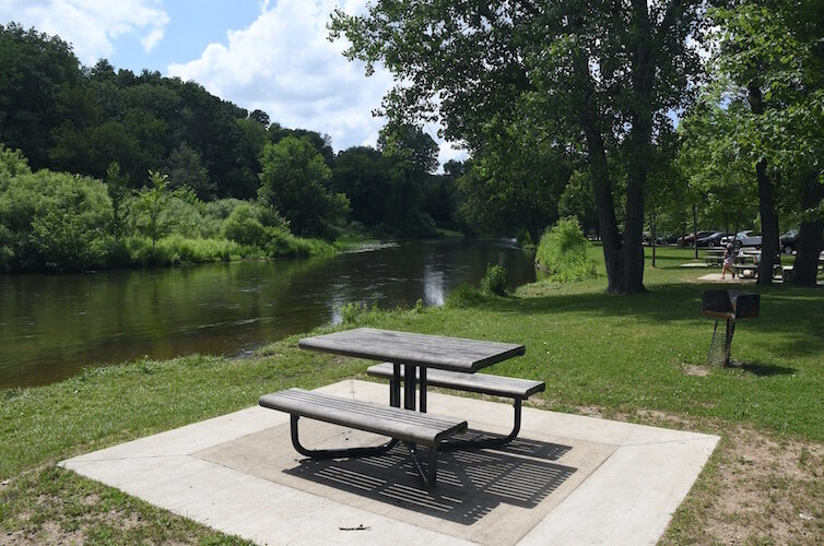 Picnic area along the Kalamazoo River in Historic Bridge Park.