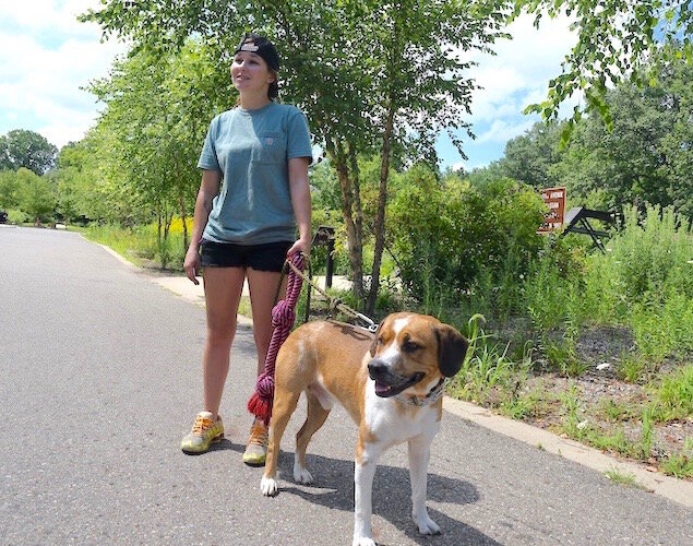 Aubrey Greenfield of Battle Creek brings her dog Clutch often to walk at Historic Bridge Park.