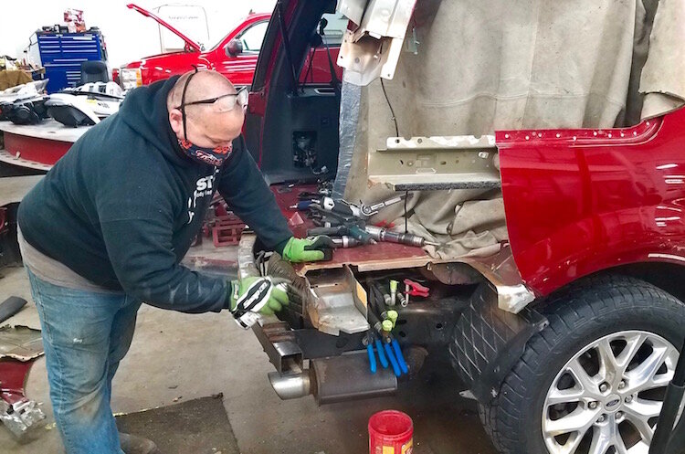 Service technician Michael Paddock works on a truck at CARSTAR Kalamazoo.