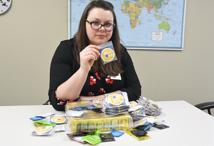 ristin McDermott of the Calhoun County Health Department with some of the condoms they provide free.