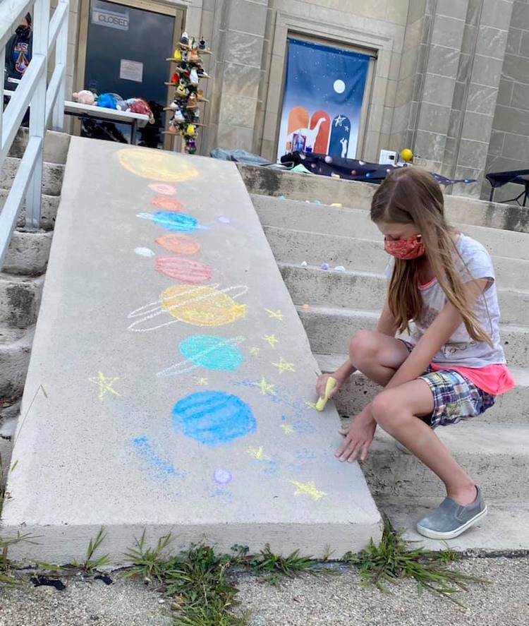 Summer campers decorate the steps leading up to the museum entrance with sidewalk chalk as they follow social distancing guidelines.