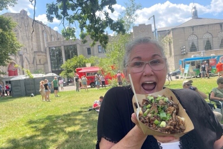 Chef Channon Mondoux enjoys some Canadian poutine.