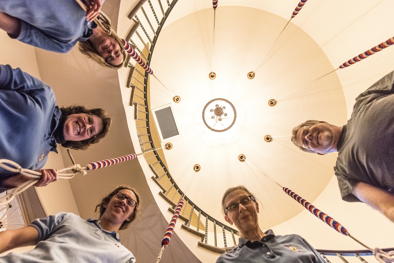 Kalamazoo Choral Arts Holiday Concert: The Kalamazoo Bell Ringers posed as Fran lay on the floor looking up for the shot.