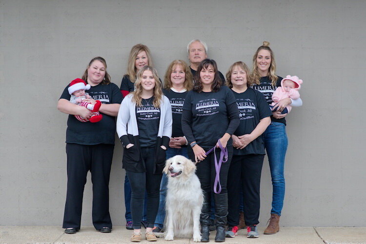  Plumeria employees pose for a Christmas card photo.