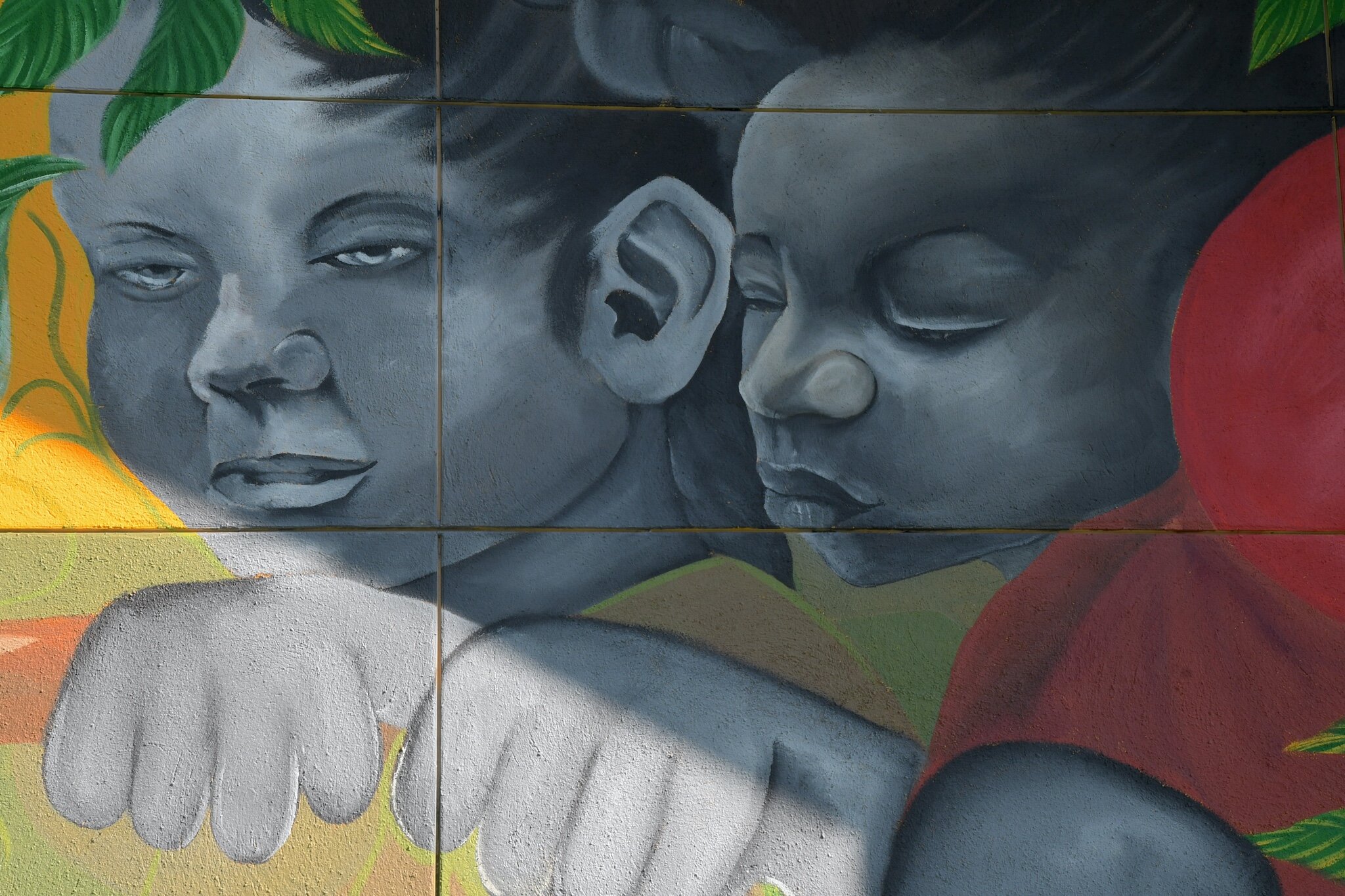 Close up scenes of Jamari Taylor’s mural on one of the walls of Trinity Neighborhood Center