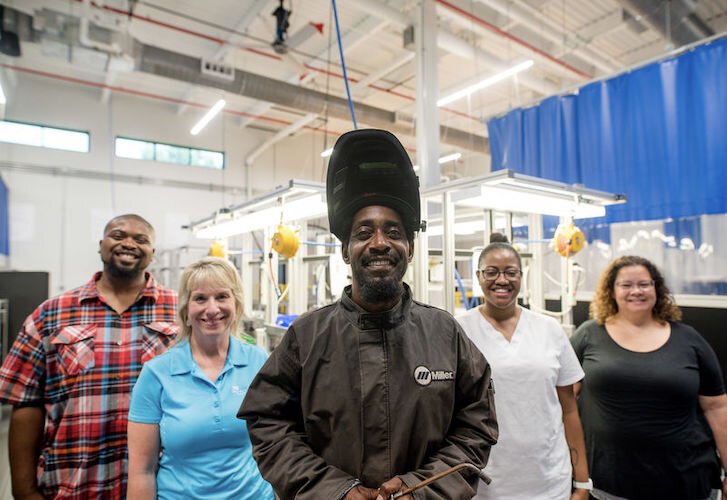 Graduates of iACT programing photographed with staff showing the different career paths that are now open to them from receiving training and assistance from the workforce development consortium partners.