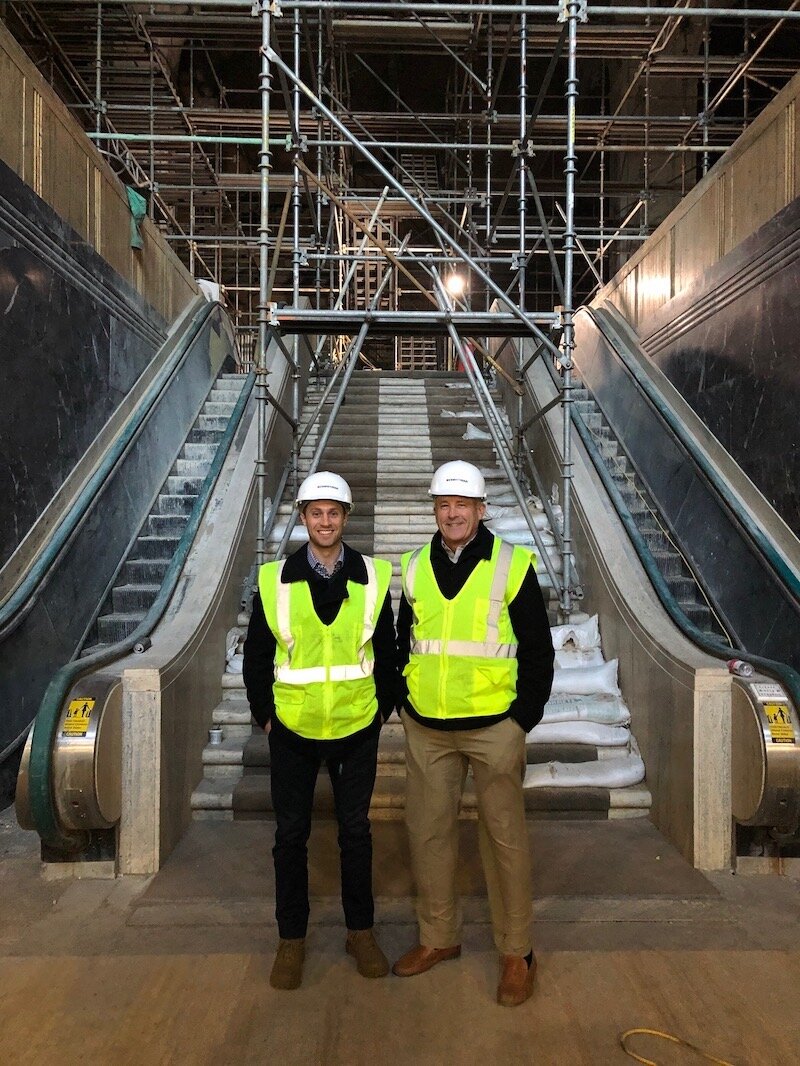 Mark Harmsen, at right, founder and president of MDH Development LLC, and his son, Dan, co-developer of The Milton, stand in the building's lobby while restoration work was going on.  Harmsen owns The Milton.