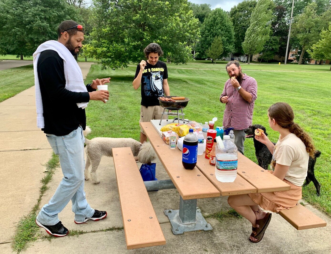 Dog lovers congregate on Thursday evenings to grill hotdogs and socialize at the Fairmount Dog Park on Prairie Street in the West Douglas Neighborhood.