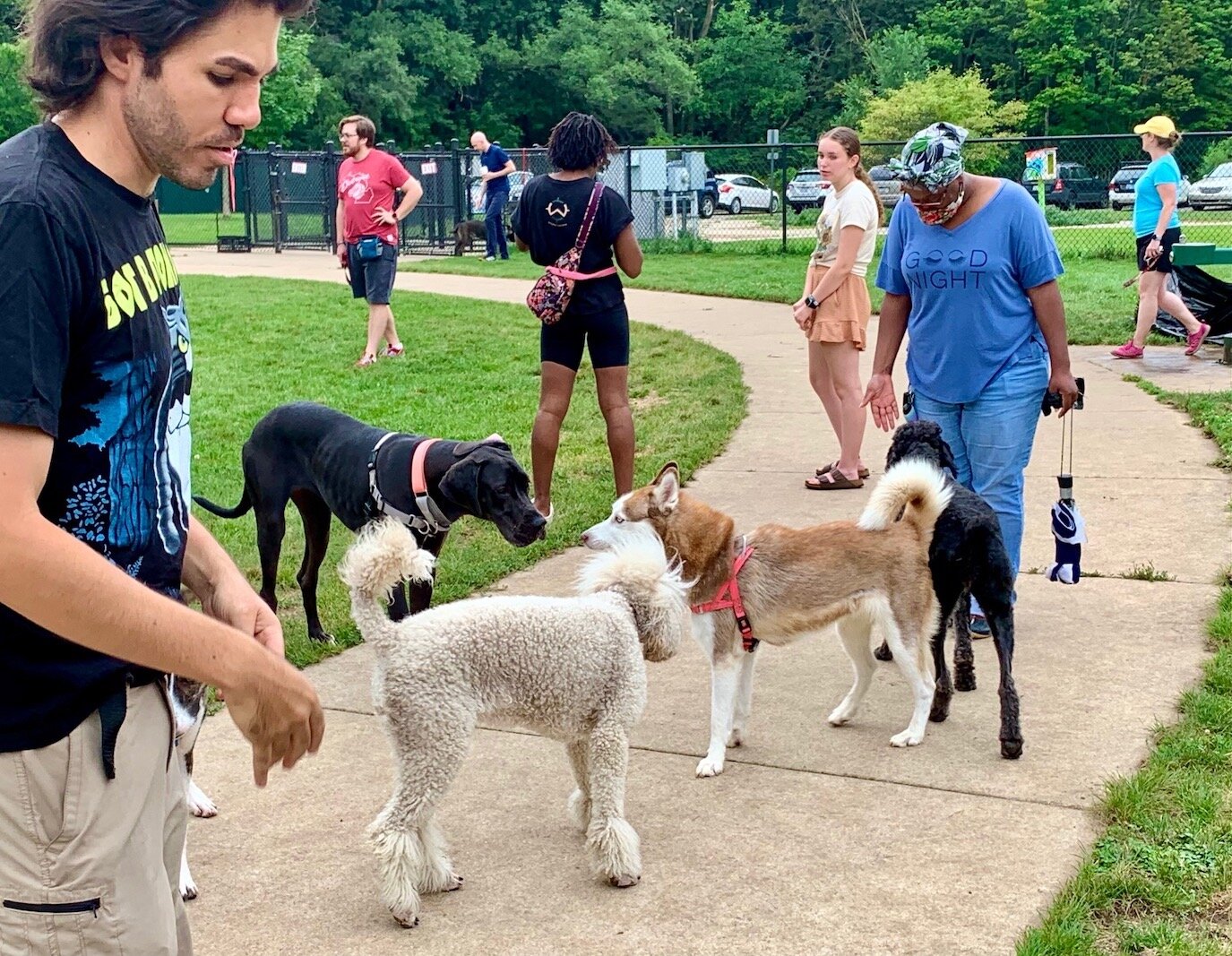 Josh Paris, left, is among those whose pets have found a regular place to socialize at the Fairmount Dog Park on Prairie Street in the West Douglas Neighborhood.