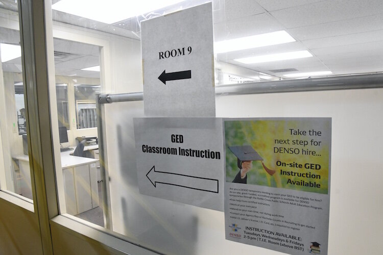 Signs inside the DENSO plant in Ft. Custer point toward the room where GED instruction occurs.