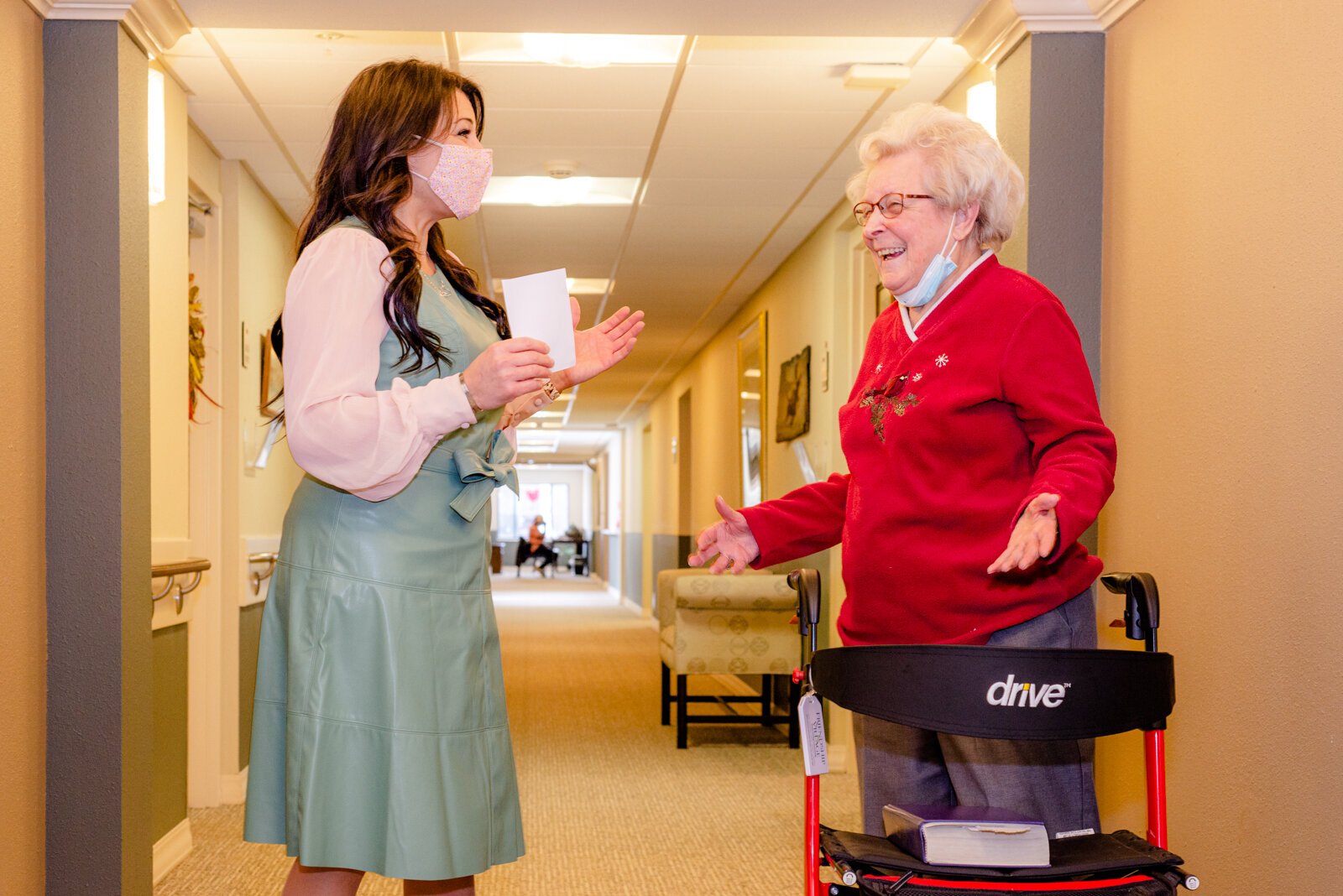 Diana Duncan with a resident at Friendship Village, where they recognize staff and caregivers with gifts and cash awards. 
