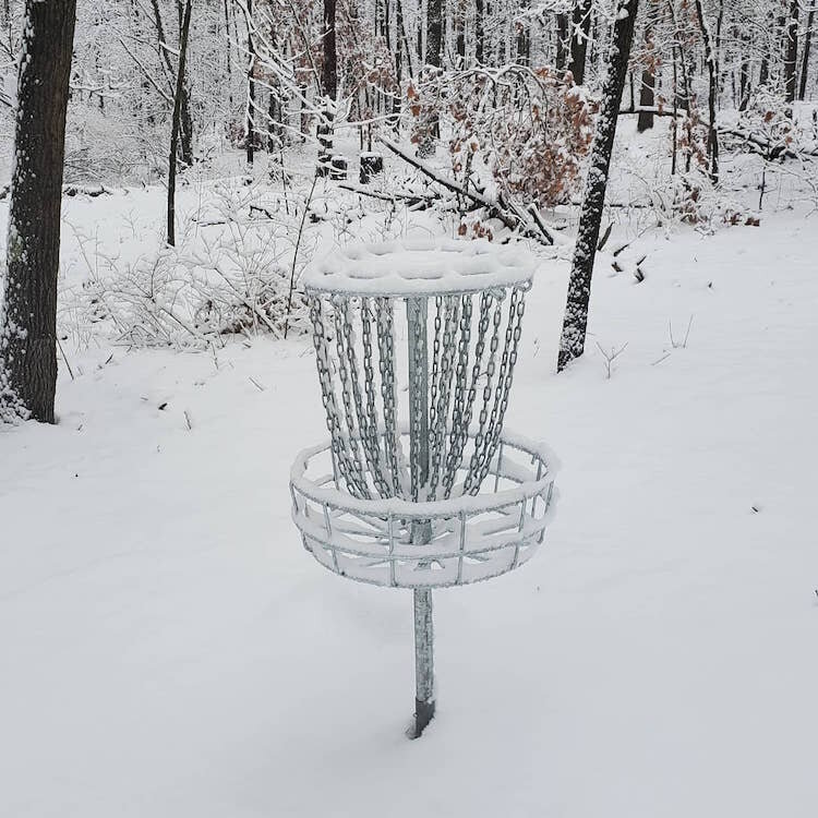 A raised disc golf basket located along the course.