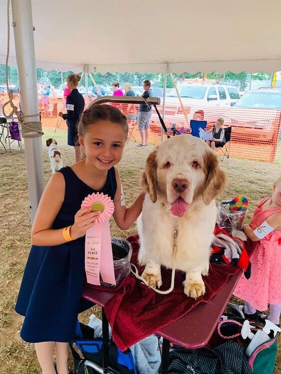 A young person with her 1st place winning dog at the 4-H Fair last year.