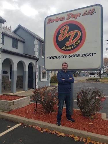 Thomas Woodin, who co-owns Serious Dogs with his brother, James, stands outside the location of their new brick and mortar location.  They expect to open their eatery in early December.