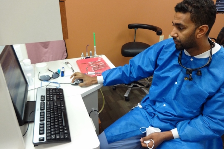 Dr. Haitham Eljack checks an x-ray on the computer screen