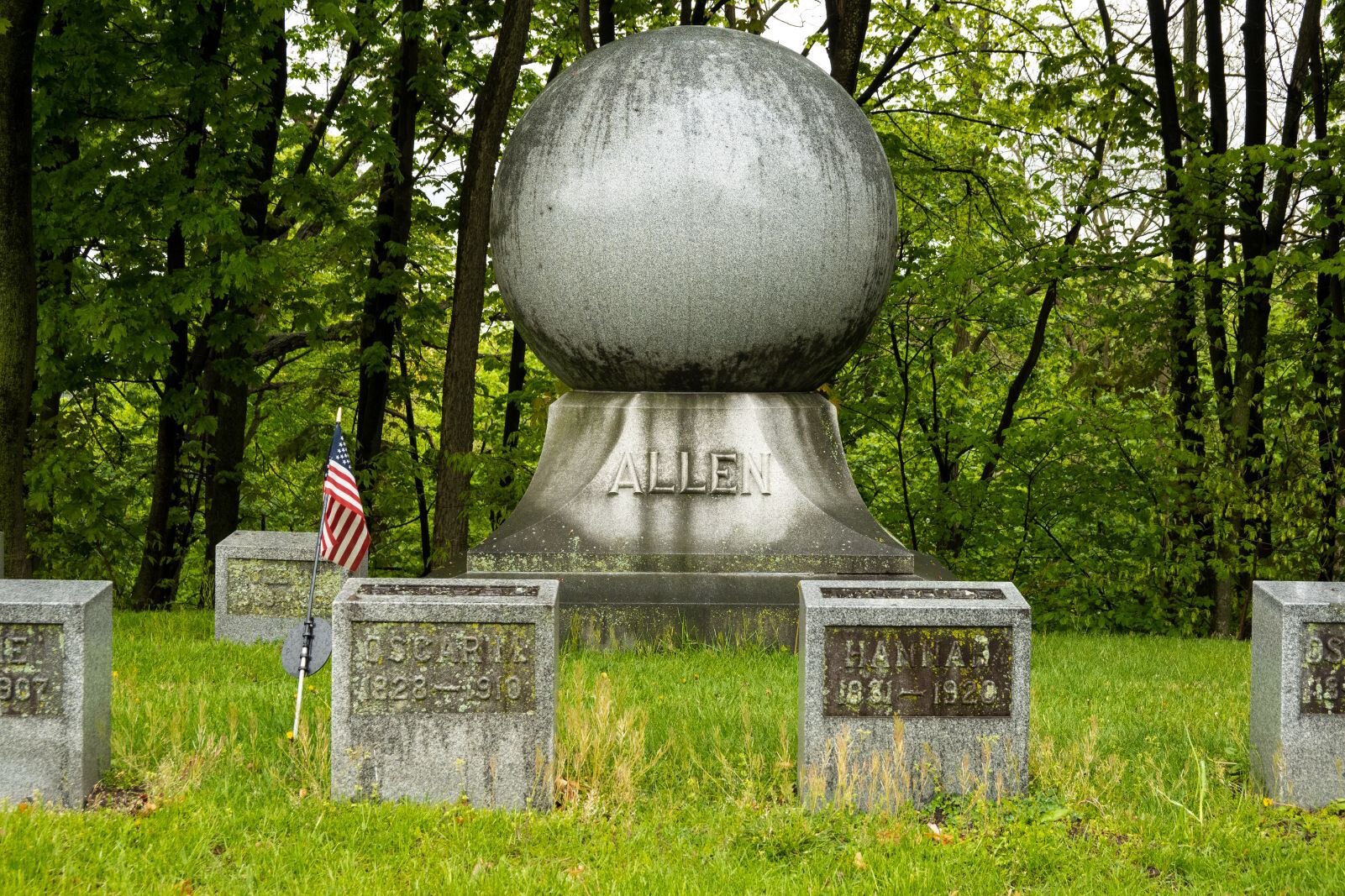 This boulder-sized orb marks the family burial plot of the Oscar Allen family. He was owner of the Globe Casket Manufacturing Co.