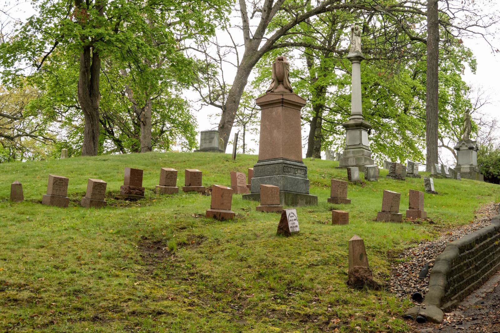 Family obelisks often recognized the connection of two or more families, with headstones for members of related families adjacent to it.