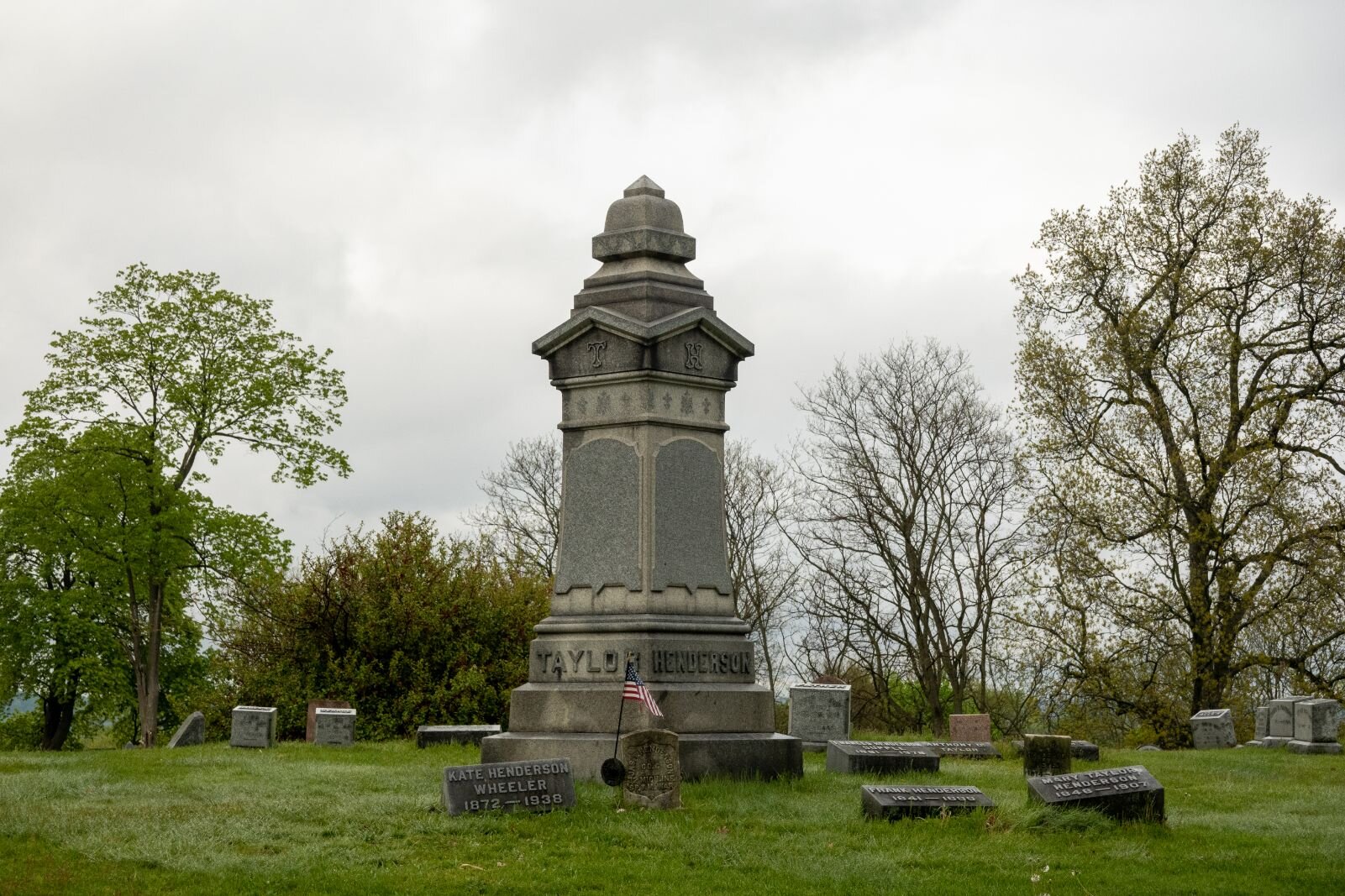 Family obelisks often recognized the connection of two or more families, with headstones for members of related families adjacent to it. Shown here is the obelisk that marks the burial plot for Frank and Mary (Taylor) Henderson and various members of