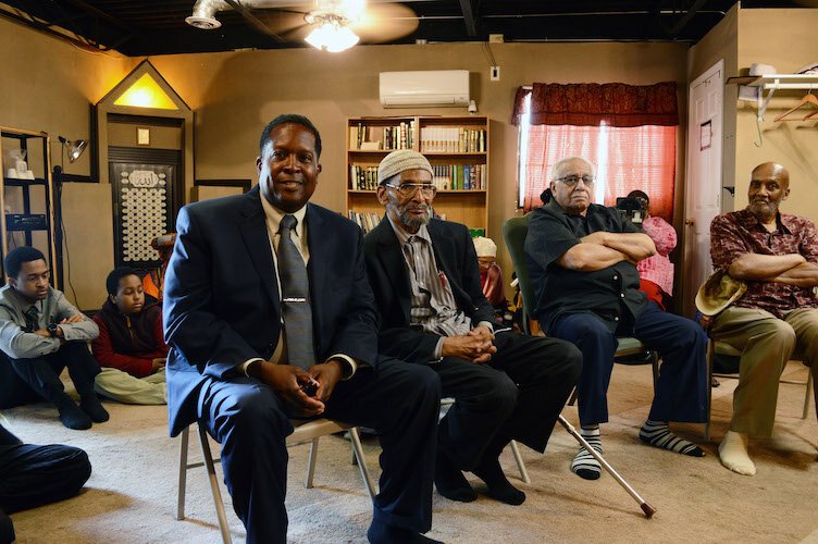  Imam Warithudeen Mohammed II (front-left)  of The Mosque Cares, visiting Bilal Islamic Center before giving a speech at the Douglass Community Association Aug. 10. 
