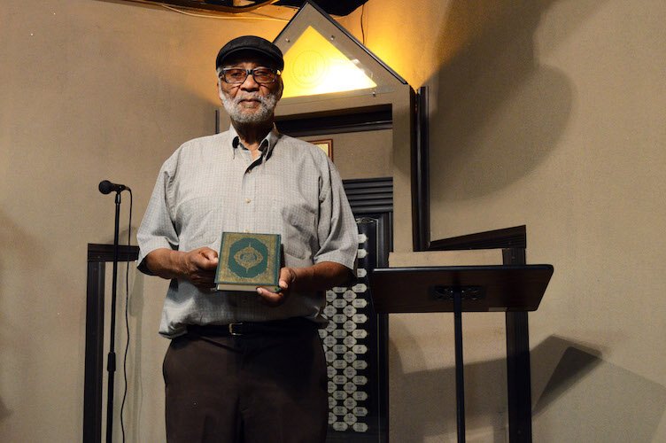 Imam Hassan Mateen, holding his Koran in the mosque of Bilal Islamic Center, Eastside Kalamazoo.