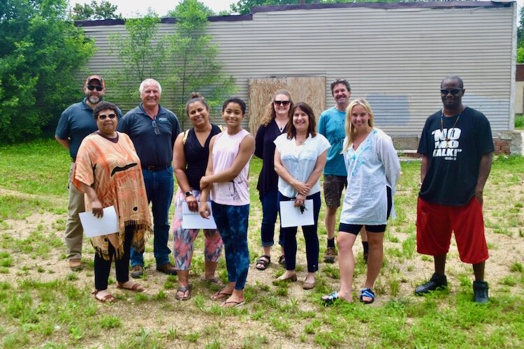 Pat Taylor of the Eastside Neighborhood Association, in the front at left wearing sunglasses, stands recently at the site with members of the Eastside Sunrise Design Team and members of the community.