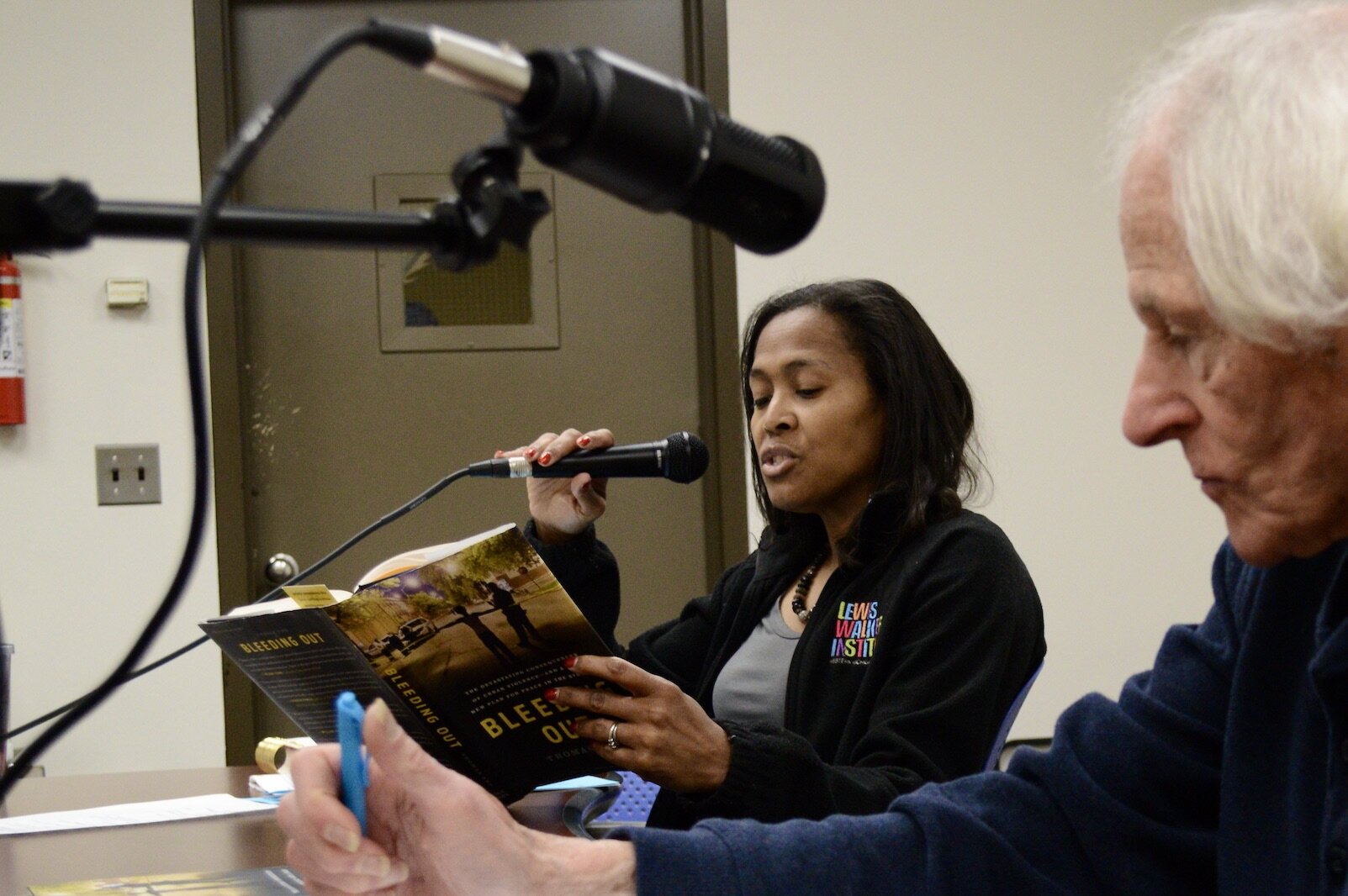 Luchara Wallace, director of Western Michigan University's Walker Institute for the Study of Race and Ethnic Relations, reads from her well-read copy of "Bleeding Out." 