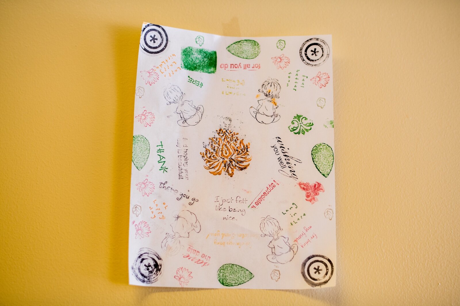 Brandon Mion shows a sheet of paper stamped with messages of hope and thanks sent to him by youth he mentors at The Ark.