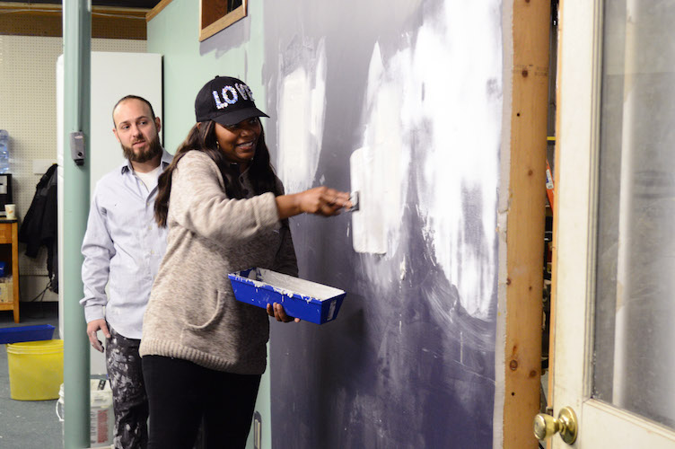 Participants in a Community Homeworks class learn the art of drywall.