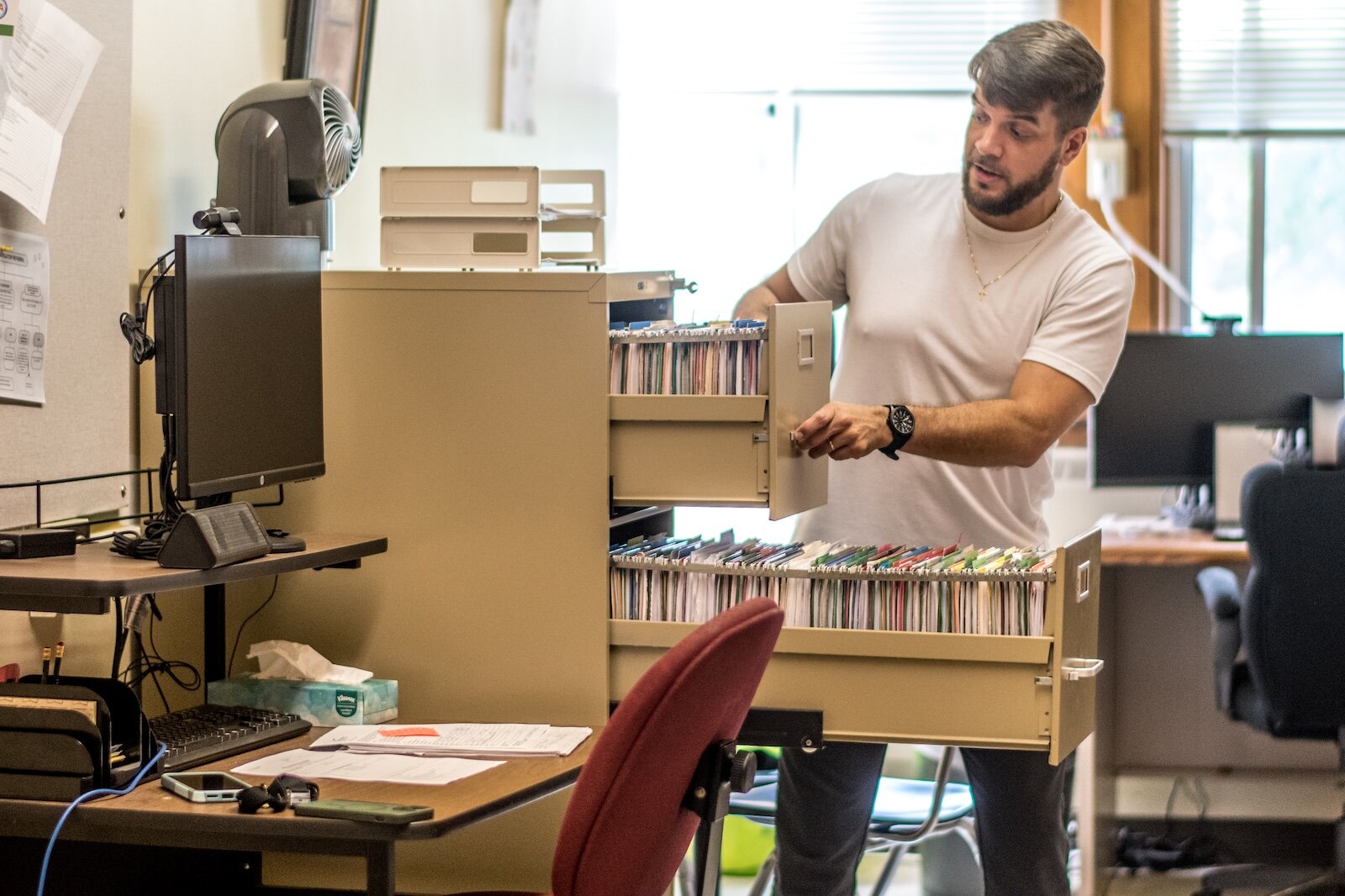 In his office, Brandon Mion has drawers full of Kalamazoo families who've been helped, and who need help.