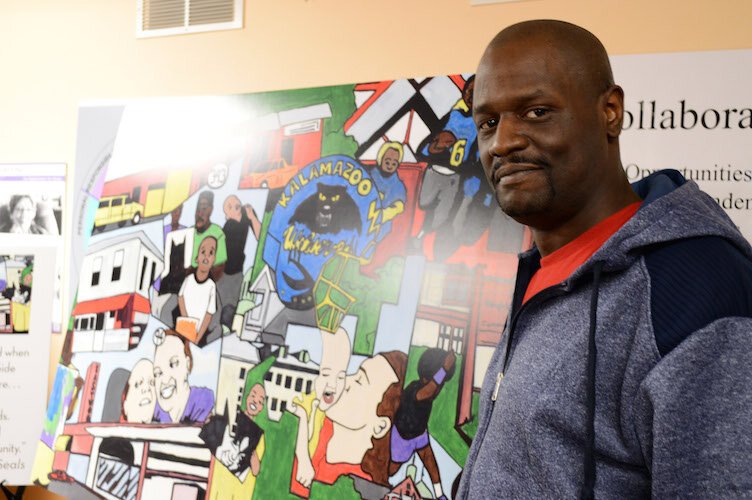 Artist Gerald King with his ”Memories of the Eastside.”