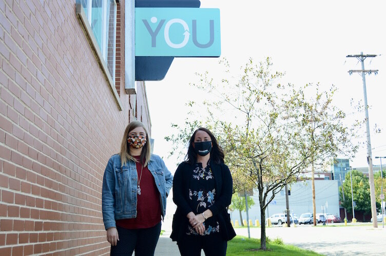 From left, Molly Fitz Henry, YOU manager of special initiatives, and Paige Daniels, YOU director, outside of YOU’s Kalamazoo offices.