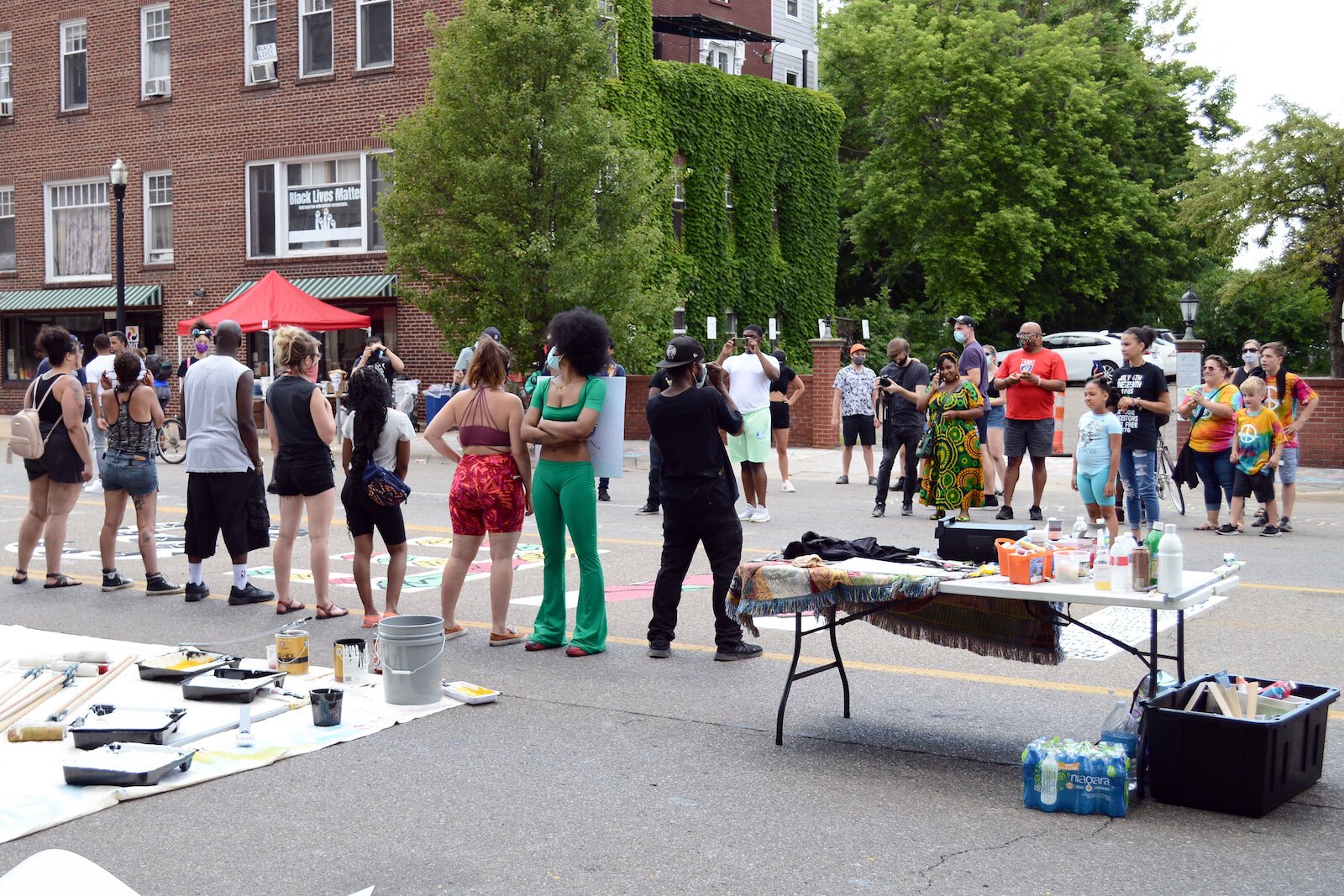 People watch artists downtown creating Kalamazoo Black Lives Matter street art, June 19. 