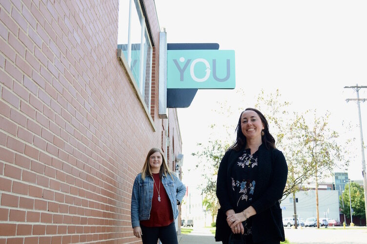 From left, Molly Fitz Henry, YOU manager of special initiatives, and Paige Daniels, YOU director, outside of YOU’s Kalamazoo offices.