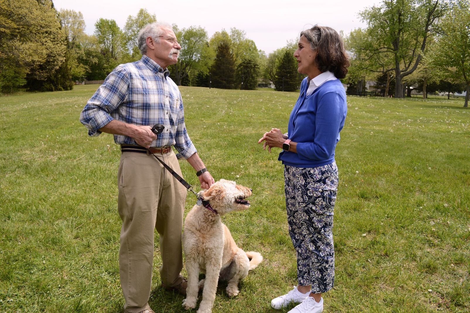 Lake Center District resident Paul Blostein, (with his dog, Sugar) tells Mayor Randall that he's worried the city is trying to make the district a "downtown" of Portage. She explains that this is not the goal of the study.