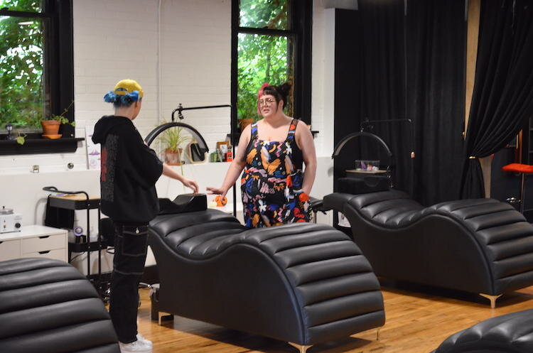The black comfy salon tables that were designed specifically for comfort, and for different body and ability types. 