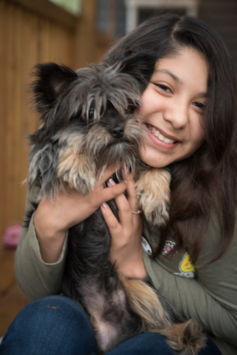 Esto's daughter, Nila, with the family dog. Photo by Fran Dwight.